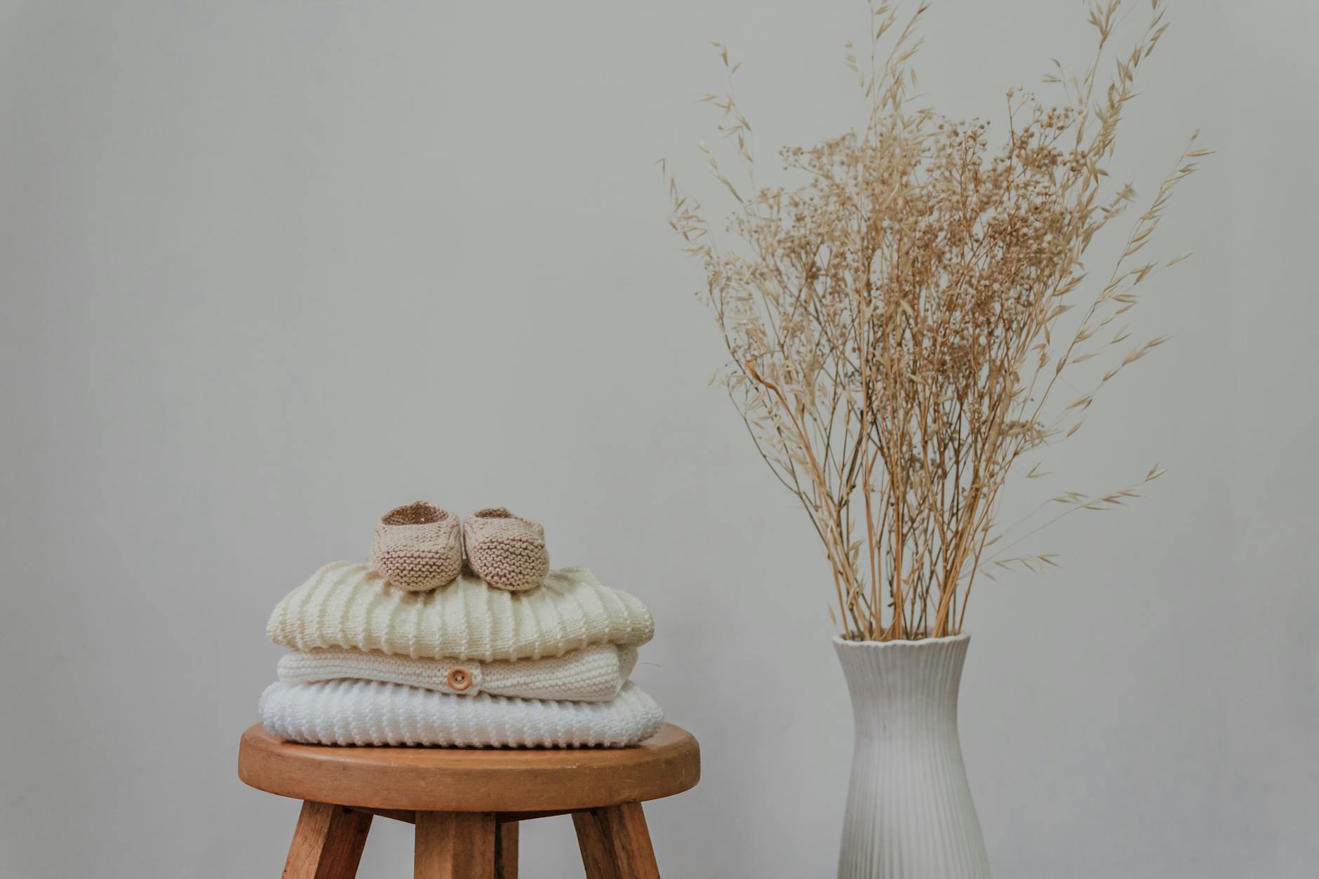 knitted fabrics on brown wooden round stool